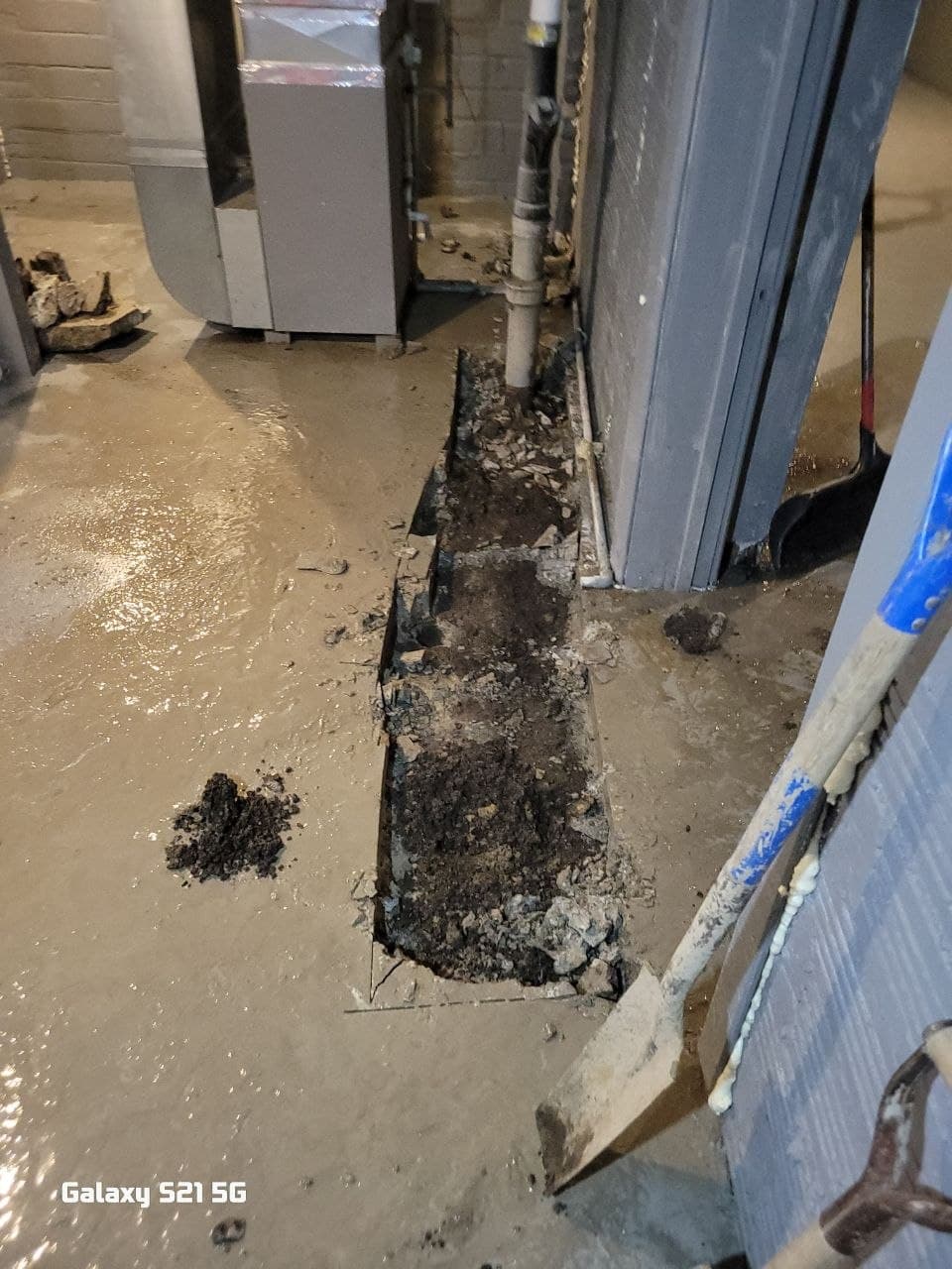 Laborer prepping a site — floor protection down, debris cleared