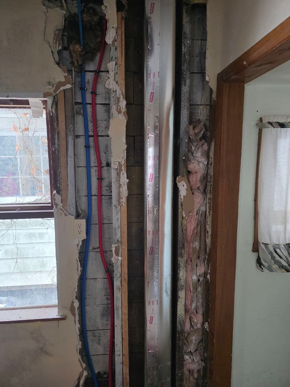 Fresh PEX supply lines run in an opened wall