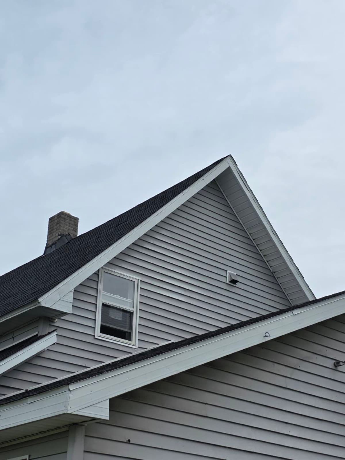 Wrapped fascia and rake trim along a gable end
